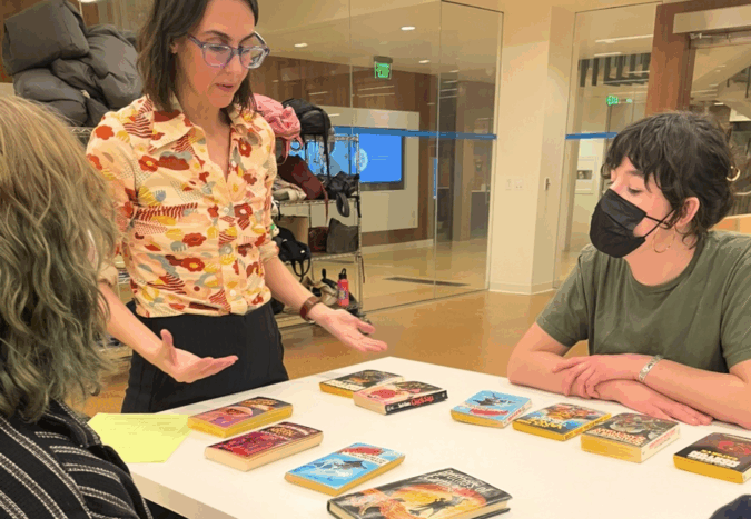 Jet Jacobs, head of public services, outreach and community engagement and interim assistant director of UCLA LSC discusses sci-fi pulp novels with students