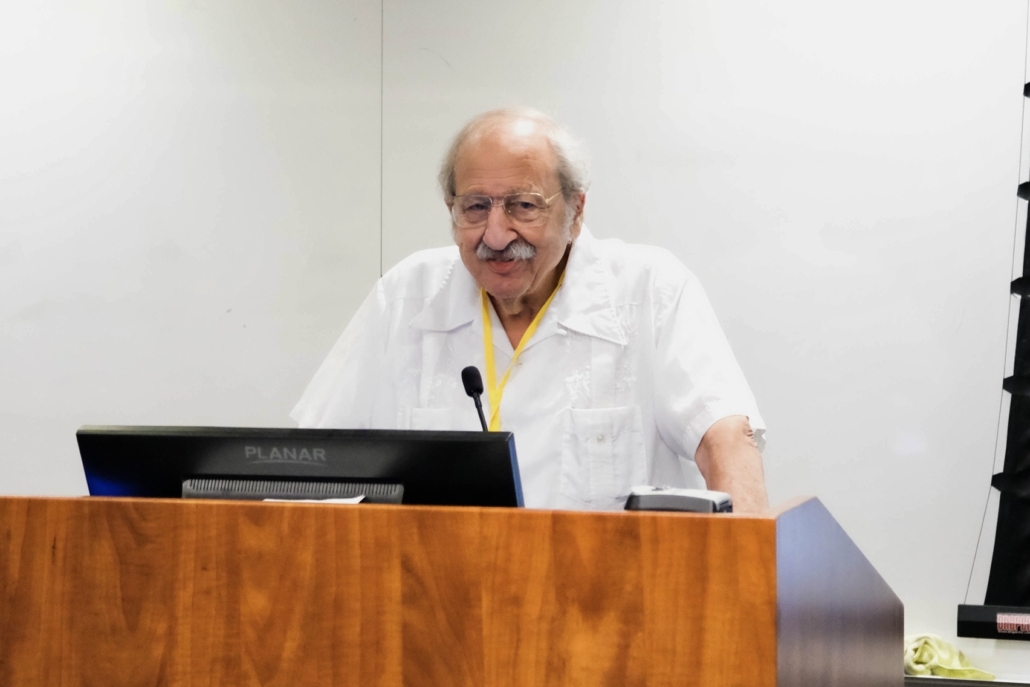 Marshall Ganz stands at a podium at the 2025 SLRC