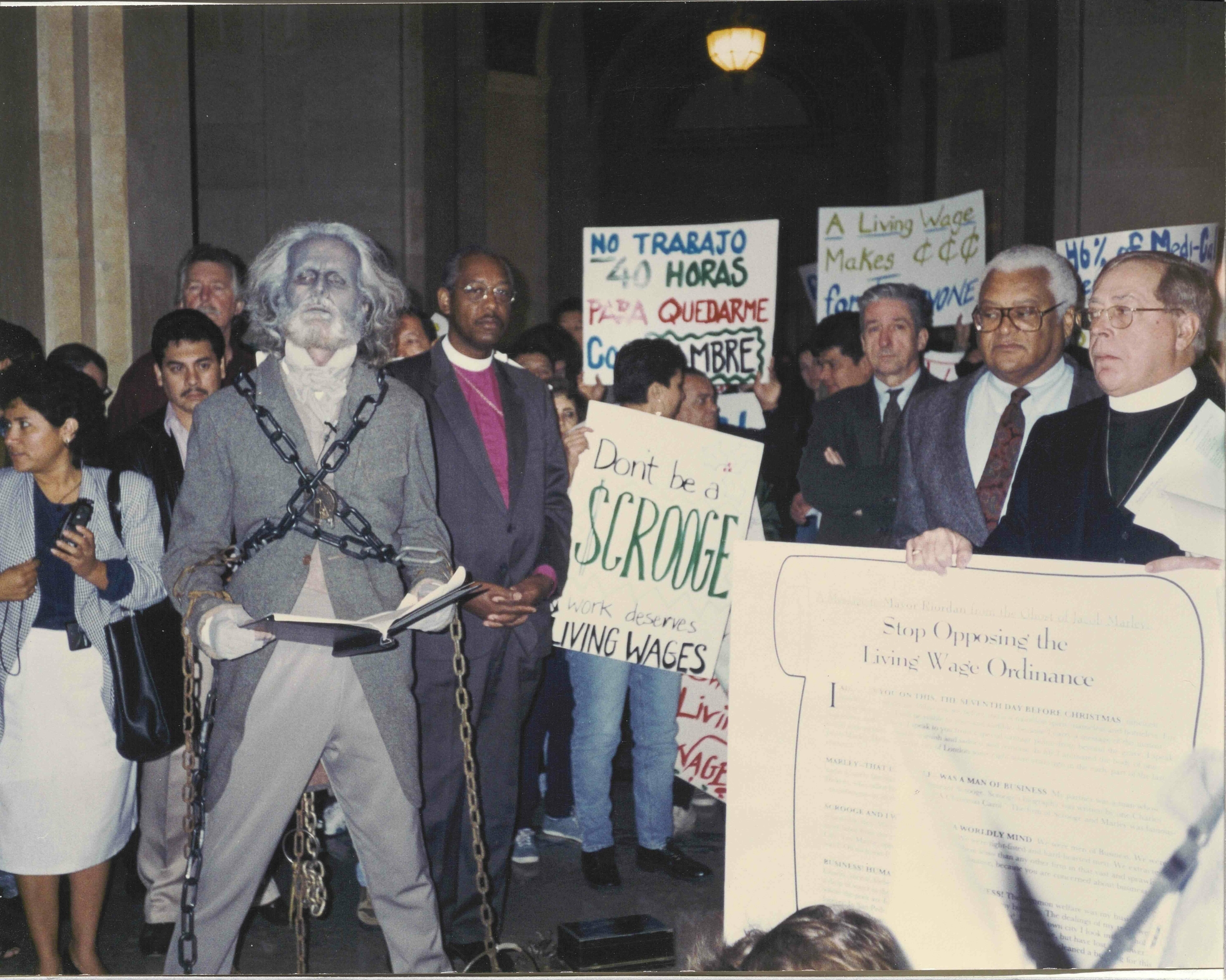 Flanked by religious leaders from CLUE, including Rev. James Lawson Jr., Suffragen Bishop Chester Talton, and Father Joseph Frazier, Dave Clennon addresses the press in advance of a City Council hearing on the Living Wage Ordinance in December 1996. Linda A. Lotz Photo Collection, IRLE Archives.
