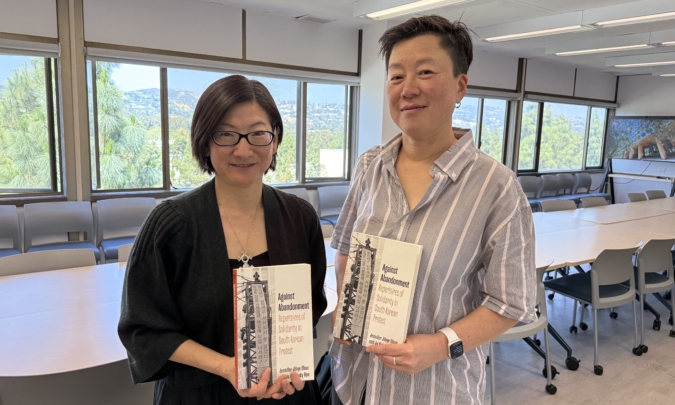 Jennifer Jihye Chun and Ju Hui Judy Han pose with their book Against Abandonment: Repertoires of Solidarity in South Korean Protest / UCLA Labor Studies