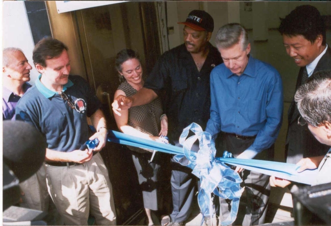 UCLA IRLE leaders and labor movement activists participate in the ribbon-cutting ceremony at the Downtown UCLA Labor Center. Standing at the ribbon (left to right): IIR Director Ruth Milkman; Rev. Jesse Jackson; Governor Gray Davis; Kent Wong; Miguel Contreras, September 2, 2002 / IRLE Archives